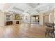 Open living room with fireplace, wood floors, tray ceiling, and natural light at 12168 Dorada Coast Ave, Las Vegas, NV 89138