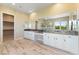 This spacious main bathroom features wood look tile floors, double sinks, and a walk-in closet at 12168 Dorada Coast Ave, Las Vegas, NV 89138