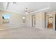 Spacious main bedroom with a tray ceiling, ceiling fan, carpeted floors, and two windows at 12168 Dorada Coast Ave, Las Vegas, NV 89138