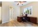 Home office with shuttered window, wood floors, ceiling fan and an open entrance to another room at 12168 Dorada Coast Ave, Las Vegas, NV 89138