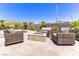 Inviting patio area with comfortable seating around a cozy fire pit, perfect for outdoor gatherings at 12168 Dorada Coast Ave, Las Vegas, NV 89138