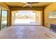 Spacious covered patio with tiled flooring, ceiling fan, and views of the landscaped backyard at 12168 Dorada Coast Ave, Las Vegas, NV 89138