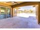 This spacious patio has travertine tile and views of the backyard's pool and covered dining area at 12168 Dorada Coast Ave, Las Vegas, NV 89138