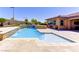 In-ground pool and spa with decorative rock waterfall feature, with the home visible in the background at 12168 Dorada Coast Ave, Las Vegas, NV 89138