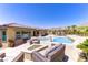 Backyard oasis with inviting pool, outdoor seating, and mountain views at 12168 Dorada Coast Ave, Las Vegas, NV 89138