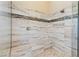 Close-up of tiled shower with bench, glass enclosure, and mosaic accents at 12168 Dorada Coast Ave, Las Vegas, NV 89138