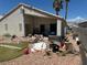 Backyard view with debris strewn across the property including a cut stump at 1409 Velvet Leaf Dr, North Las Vegas, NV 89032