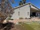 Backyard view with debris and various items strewn across the property with a bare tree at 1409 Velvet Leaf Dr, North Las Vegas, NV 89032