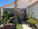 Close up of the front entrance including desert landscaping, a metal window grate, and a security door at 1409 Velvet Leaf Dr, North Las Vegas, NV 89032