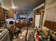 Kitchen with breakfast bar and oak cabinets is filled with various items and clutter at 1409 Velvet Leaf Dr, North Las Vegas, NV 89032