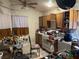 Kitchen featuring oak cabinets, tile floor, and significant clutter on the counters at 1409 Velvet Leaf Dr, North Las Vegas, NV 89032