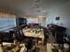 Cluttered living room boasts a dining set, sofas, and large windows at 1409 Velvet Leaf Dr, North Las Vegas, NV 89032