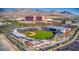 Aerial view of a baseball stadium and surrounding commercial buildings against a backdrop of mountains at 1467 Melodic Lark Ln, Las Vegas, NV 89138