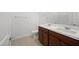 Modern bathroom with double sinks, dark wood cabinets and tile flooring at 1467 Melodic Lark Ln, Las Vegas, NV 89138