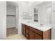 A dual sink vanity with quartz countertops and dark wood cabinets offers lots of storage space and style at 1467 Melodic Lark Ln, Las Vegas, NV 89138