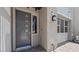 Contemporary front entry with a modern gray door, stylish hardware, and accent lighting at 1467 Melodic Lark Ln, Las Vegas, NV 89138
