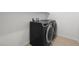 New black front load washer and dryer in a spacious laundry room at 1467 Melodic Lark Ln, Las Vegas, NV 89138