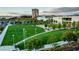 A manicured park features green lawn, walking paths, mature landscaping, lighting, seating and a pedestrian walkway at 1467 Melodic Lark Ln, Las Vegas, NV 89138