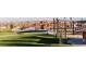 Playground and expansive green space with shade structure offering beautiful views of the city and mountains at 1467 Melodic Lark Ln, Las Vegas, NV 89138
