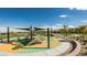 A colorful playground with shade sails and surrounding landscaping offers space for community enjoyment at 1467 Melodic Lark Ln, Las Vegas, NV 89138