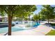 Water park with splash pad water feature under the shade of trees and a playground in the background at 1467 Melodic Lark Ln, Las Vegas, NV 89138