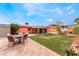 Spacious backyard featuring green lawn, covered patio, and outdoor seating area at 147 Cervantes St, Las Vegas, NV 89101