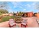 Inviting backyard with a lush green lawn, patio seating, and a charming fountain at 147 Cervantes St, Las Vegas, NV 89101