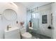 Modern bathroom featuring a glass shower with gray marble tiles, new fixtures, and a stylish sink at 147 Cervantes St, Las Vegas, NV 89101