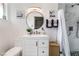Bathroom with a white vanity, round mirror, modern lighting, and a shower with marble-style tiling at 147 Cervantes St, Las Vegas, NV 89101