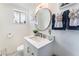 Bright bathroom featuring a modern vanity, round mirror, and stylish decor at 147 Cervantes St, Las Vegas, NV 89101