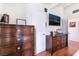 Bedroom featuring wood floors, two dressers, and a mounted television at 147 Cervantes St, Las Vegas, NV 89101