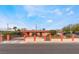 Single-story home featuring a well-kept lawn, privacy hedges, and a charming iron gate at 147 Cervantes St, Las Vegas, NV 89101