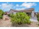 Well-maintained backyard with gravel landscaping, a patio, and flowering shrubs, ideal for outdoor living at 2244 Shadow Canyon Dr, Henderson, NV 89044