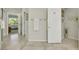Neutral-toned bathroom hallway featuring tile flooring and white towels at 2244 Shadow Canyon Dr, Henderson, NV 89044