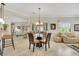 Open-concept dining space with tile floors, shutters, and a view into the living room at 2244 Shadow Canyon Dr, Henderson, NV 89044