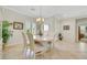 Elegant dining room featuring tile flooring, a chandelier, and plantation shutters for plenty of light at 2244 Shadow Canyon Dr, Henderson, NV 89044