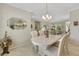 Open dining room featuring tile flooring, a chandelier, with a view to the living spaces in the home at 2244 Shadow Canyon Dr, Henderson, NV 89044