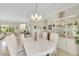 Open dining room features tile flooring, a chandelier, and flows effortlessly into the living room and other living spaces at 2244 Shadow Canyon Dr, Henderson, NV 89044