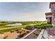 Scenic view of the golf course and water feature from an outdoor patio with seating at 2244 Shadow Canyon Dr, Henderson, NV 89044