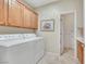 Laundry room with washer, dryer, and upper cabinetry provides ample storage and convenience at 2244 Shadow Canyon Dr, Henderson, NV 89044