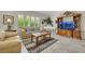 Inviting living room with shutters, tile flooring, and a comfortable seating arrangement at 2244 Shadow Canyon Dr, Henderson, NV 89044