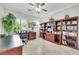 Office with built-in shelving, tile flooring, and a bright shuttered window at 2244 Shadow Canyon Dr, Henderson, NV 89044