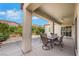 Inviting covered patio featuring a ceiling fan, table and chairs, with views of the landscaped yard at 2244 Shadow Canyon Dr, Henderson, NV 89044