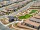 Aerial view of the community, highlighting lush green common areas and well-maintained residential streets at 25 Red Creek Bluff St, Henderson, NV 89011