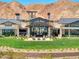 Spacious home with a lush backyard, manicured lawn, and inviting outdoor lounge area at 25 Red Creek Bluff St, Henderson, NV 89011