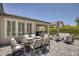 Picturesque backyard with an outdoor dining set and a comfortable seating area ideal for relaxation at 25 Red Creek Bluff St, Henderson, NV 89011