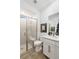 A bright bathroom featuring a glass-enclosed shower with a built-in bench and sleek, modern fixtures at 25 Red Creek Bluff St, Henderson, NV 89011