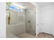 Elegant bathroom featuring a glass shower, neutral tile, and bright lighting at 25 Red Creek Bluff St, Henderson, NV 89011