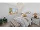 Cozy bedroom with a plush bed, soft lighting, and a view of the outdoors at 25 Red Creek Bluff St, Henderson, NV 89011