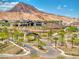 Beautiful community featuring a clubhouse, pool, and desert landscaping with mountain views in the background at 25 Red Creek Bluff St, Henderson, NV 89011